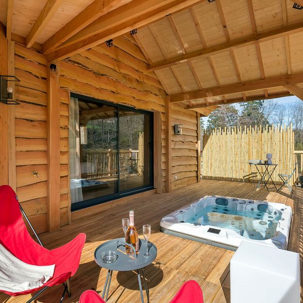 spa on terrace in front of bay window laurel hut